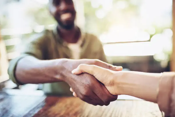 Cropped shot of two people shaking hands