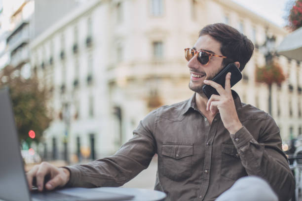 istock Man multi-tasking outdoors 869330482