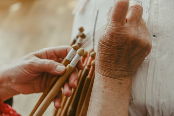 istock Needlework concept, old craft woman makes bobbin lacing or Palickovanie, hand made product creating 869331604