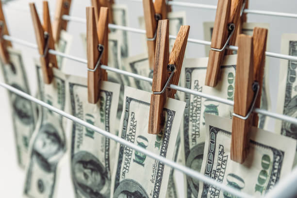 Money laundering concept. American hundred dollar bills hanging to be dry and clean cash Money laundering concept. Dryer and banknotes on clothespins. American hundred dollar bills hanging to be dry and clean cash money laundering stock pictures, royalty-free photos & images