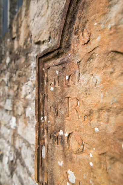 istock Old bronze tombstone with inscriptions background 869337706