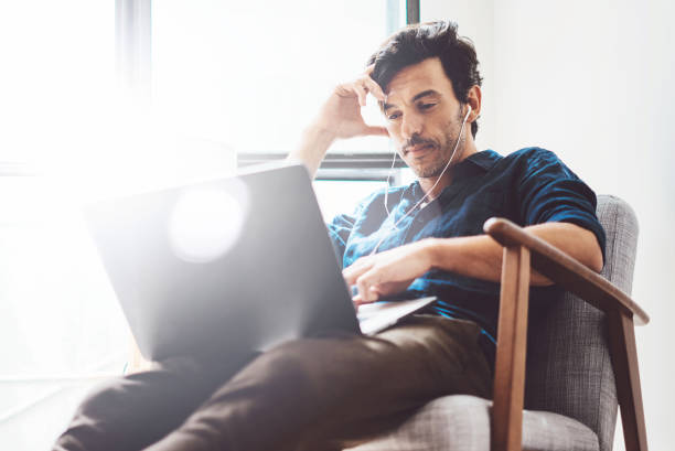istock Coworker working on modern mobile computer while sitting at the wooden table at sunny work place.Blurred background. Horizontal 869342468