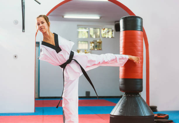 istock Adaptive athlete doing back kick to the punching bag 869345090