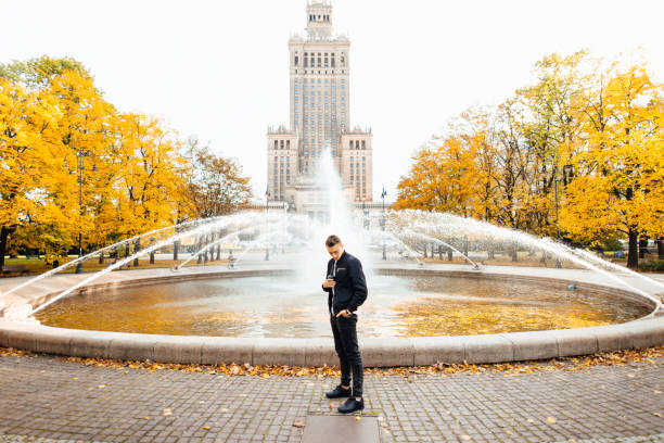 istock Man with cup of coffee talk on his phone 869345926