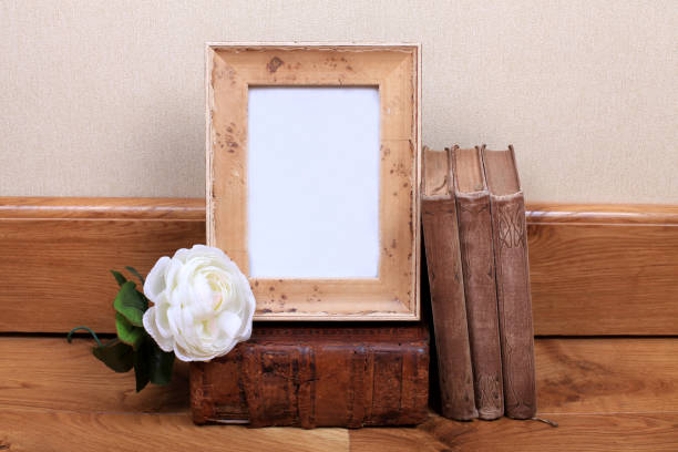 istock Vintage wood frame with old books on table. 869349432