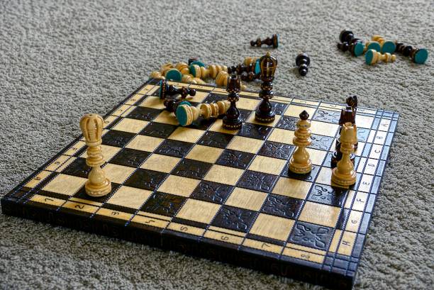 istock Chess board with chess on the grey wool carpet 869349448