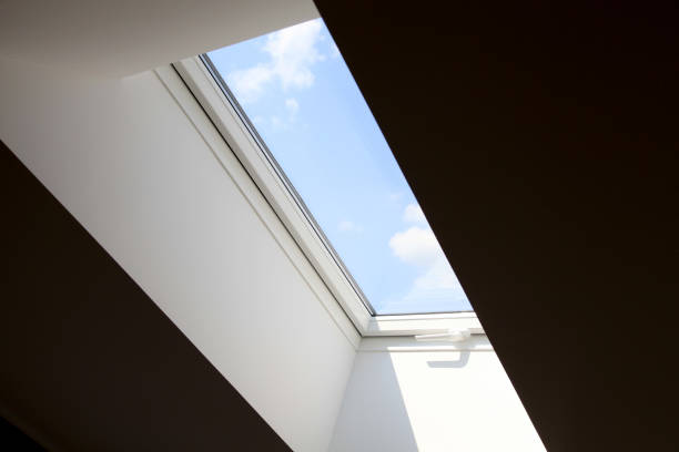 istock modern roof mansard window against blue sky 869352344