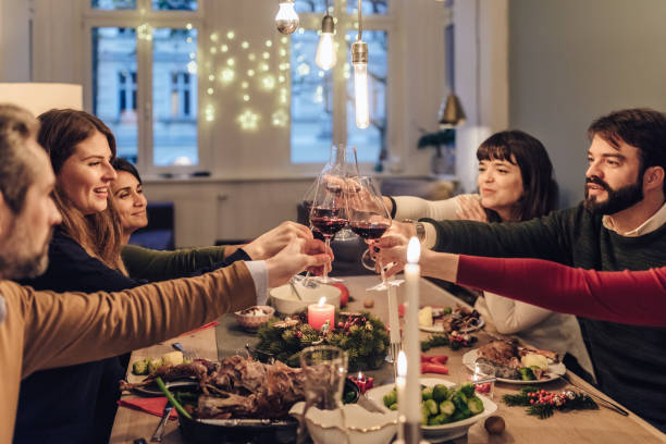 istock friends clinking wine glasses at christmas table 869356966
