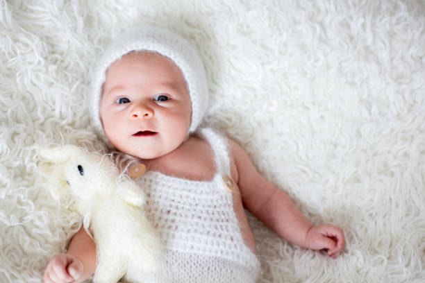 istock Beautiful newborn baby boy, looking curiously at camera 869359362