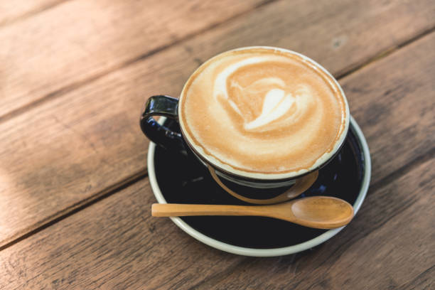 istock Coffee cup and coffee beans on wood table ,warm and good smell 869360334