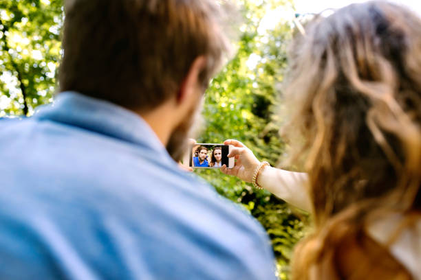 istock Young couple with smartphone taking selfie. 869364010
