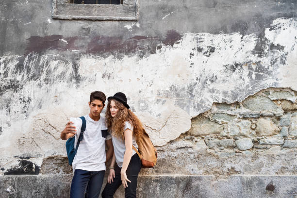 istock Two young tourists with smartphone and camera. 869367364