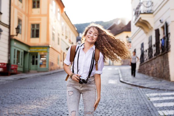 istock Young tourist with camera in the old town 869367400