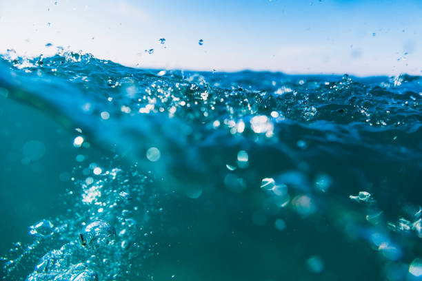 istock Underwater air bubbles in sea. Water texture with bokeh. 869371414