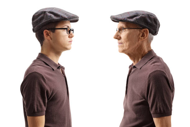 Old man looking at his younger self Old man looking at his younger self isolated on white background age contrast stock pictures, royalty-free photos & images