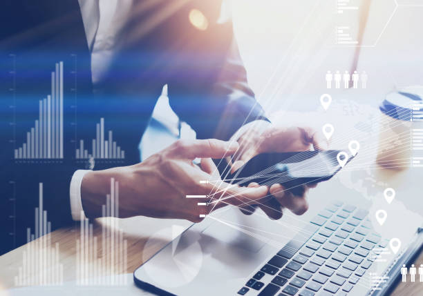 istock Businessman holding modern smartphone on hands.Concept of digital diagram,graph interfaces,virtual screen,connections icon.Blurred background. 869374152