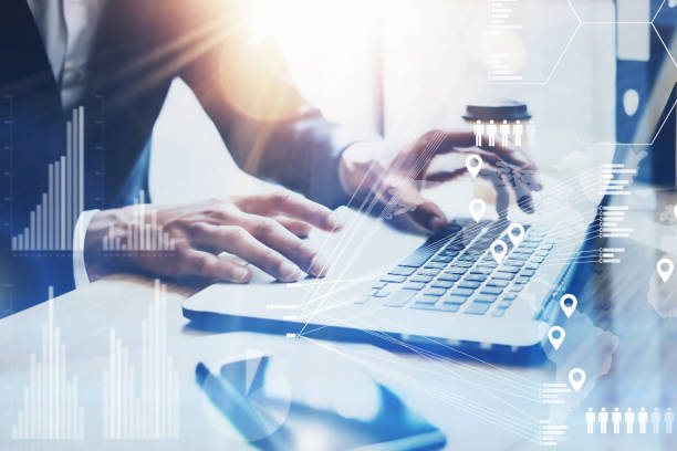 istock Concept of digital screen,virtual connection icon,diagram,graph interfaces.Businessman working at sunny office on laptop while sitting at the wooden table.Blurred background.Flares. 869375330