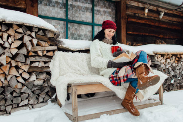 Woman enjoying time on her own on a cold winter day. stock photo