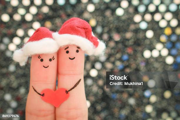 Fingers Art Of Couple Celebrates Christmas In New Year Hats Toned Image Stock Photo - Download Image Now