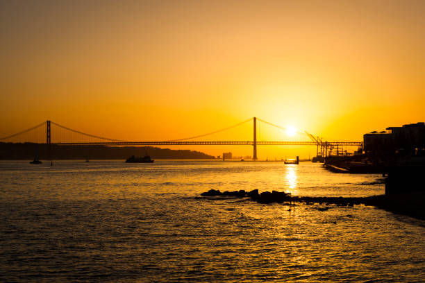 istock april 25th bridge at sunset, lisbon, portugal 869381898