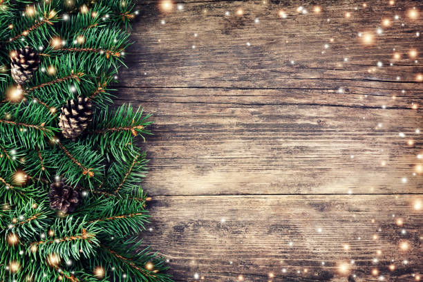 Christmas fir tree on a wooden background Christmas fir tree on a wooden background and bokeh light spinning top stock pictures, royalty-free photos & images