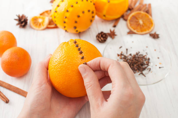 Decoration orange with cloves for the holiday Oranges for decoration for the new year. Decorating oranges with cloves for the holiday. scent container stock pictures, royalty-free photos & images