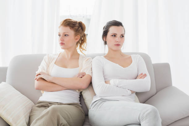 istock Unhappy friends not talking after argument on couch 869391068