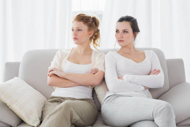 istock Unhappy friends not talking after argument on the couch 869391084