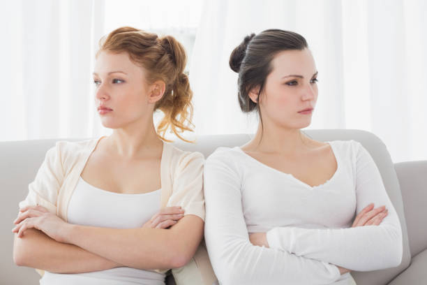 istock Unhappy friends not talking after argument on the couch 869391106