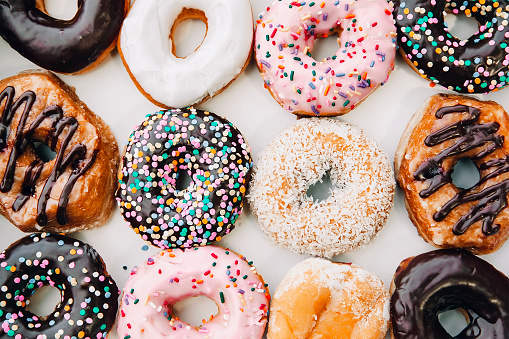 box with different donuts closeup. Texture. Flat lay, top view