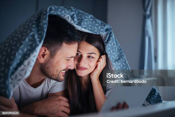 Their Sleepless Nights Are Filled With Love Stock Photo - Download Image Now - Couple - Relationship, Blanket, Digital Tablet