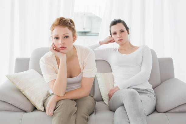istock Unhappy friends not talking after argument on the couch 869394650