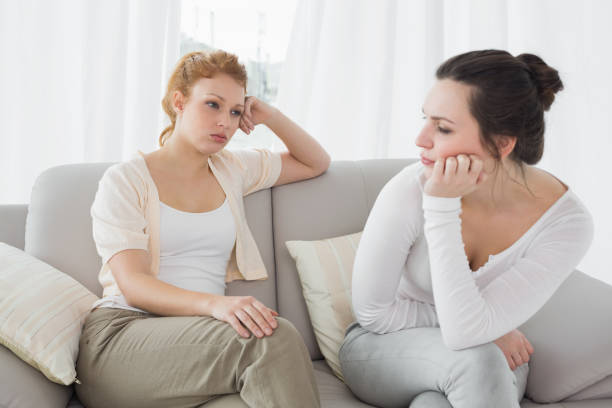 istock Unhappy friends not talking after argument on the couch 869394726