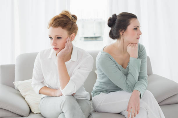 istock Unhappy friends not talking after argument on the couch 869394758