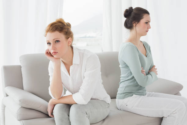 istock Unhappy friends not talking after argument on the couch 869394798