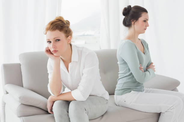 istock Unhappy friends not talking after argument on the couch 869394822