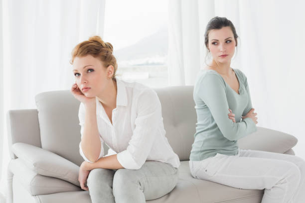 istock Unhappy friends not talking after argument on the couch 869394824