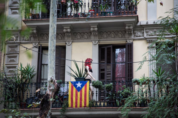 Barcelona, Spain, 19th October 2017 - Catalan flag draped over balconys claiming independance from Spain. Daytime.
