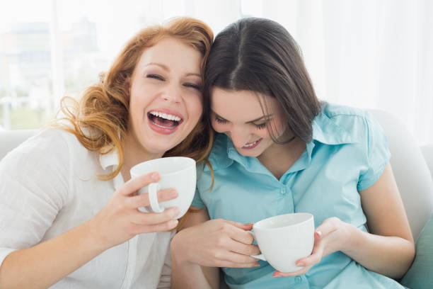 istock Friends with coffee cups enjoying a conversation at home 869401262