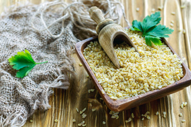 istock Bulgur and scoop in a square wooden bowl. 869401696