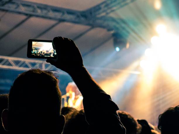 istock Concert crowd filming a stage with smart phones 869402210