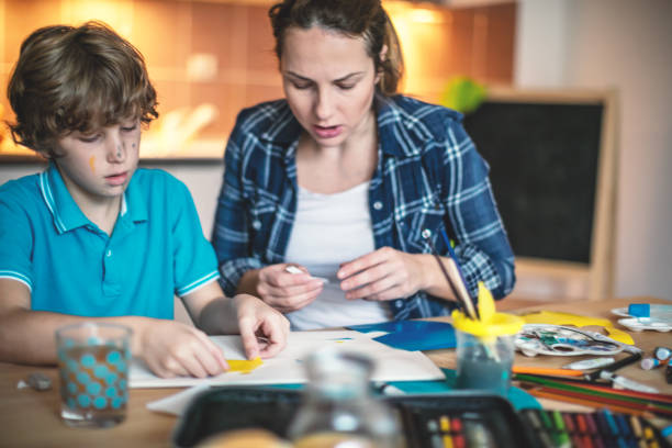 istock Mother and son making paper collage 869404864