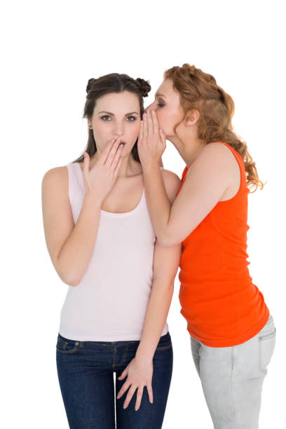 istock Two young female friends gossiping 869405646
