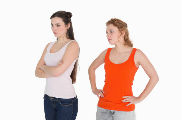 istock Unhappy young female friends not talking after argument 869405682