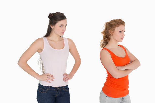 istock Unhappy young female friends not talking after argument 869405690