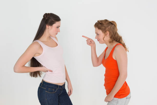 istock Angry young female friends having an argument 869406474