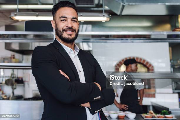 Young Businessman Standing In His Restaurant Stock Photo - Download Image Now - Restaurant, Manager, Owner