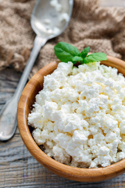 istock Wooden bowl with cottage cheese and mint. 869409332