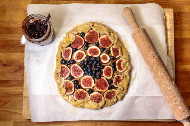 Directly above shot of a blueberry and fig galette (open pie or tart), ready to bake