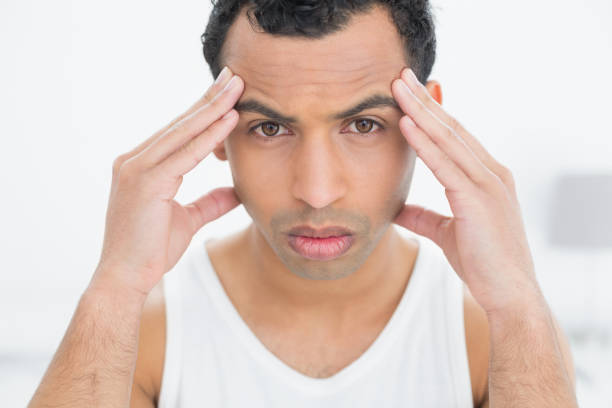 istock Closeup portrait of a man suffering from headache 869412792